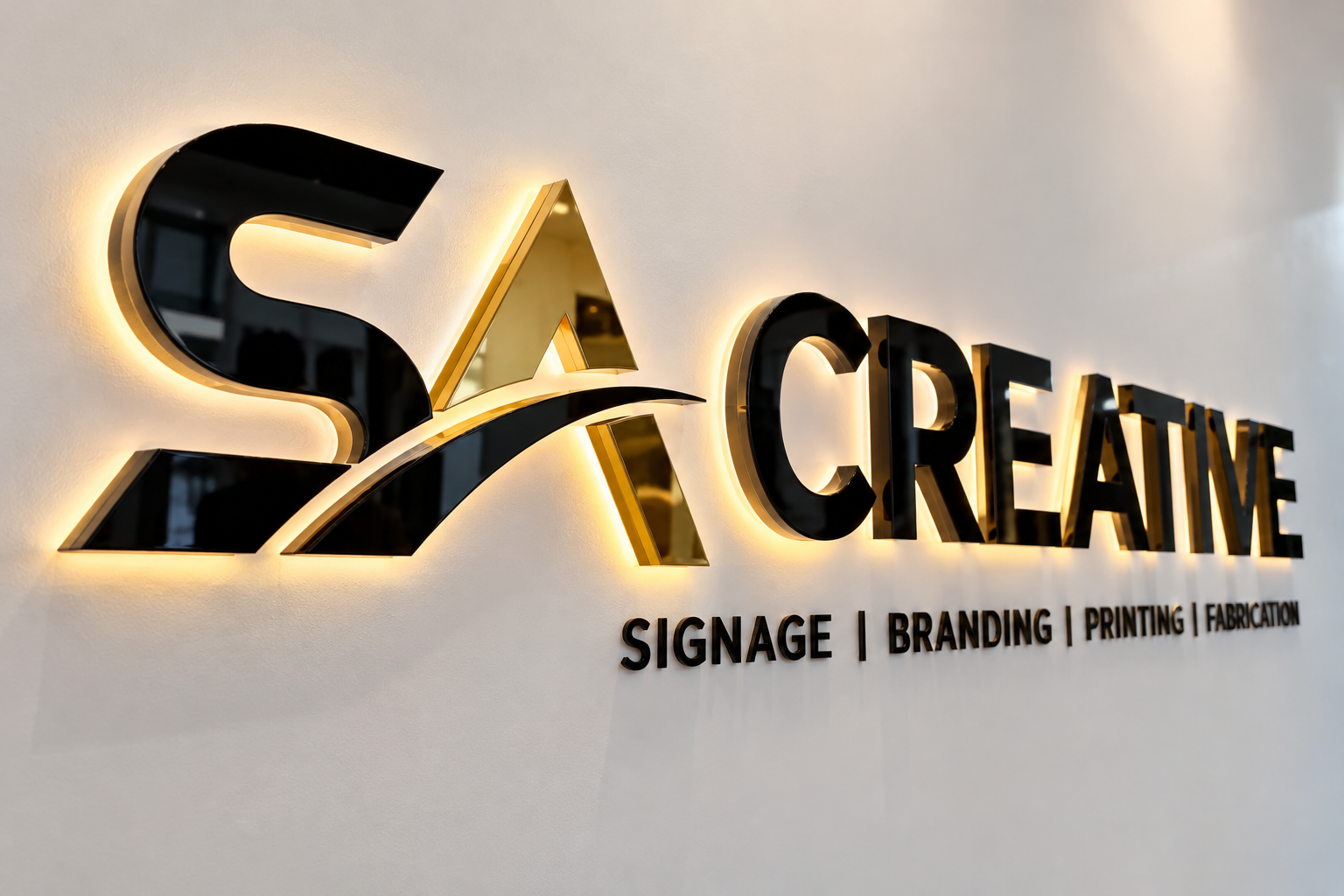 SA Creative black-and-gold dimensional sign with warm backlighting